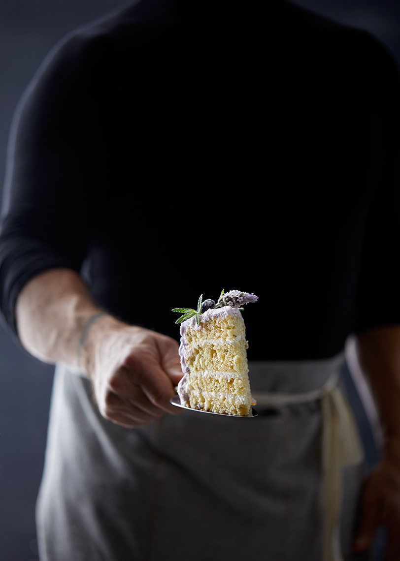 Tattooed man holding cake slice