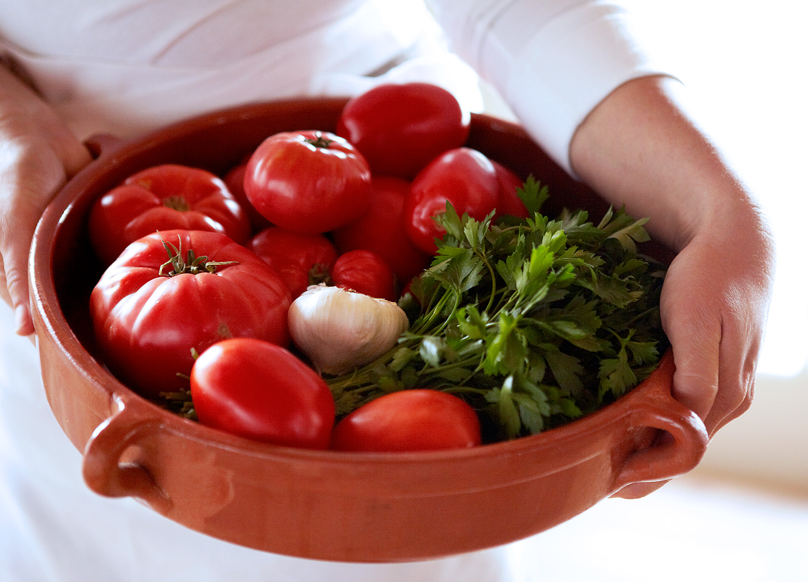 Woman Carrying Bowl of Tomatoes and Parsley